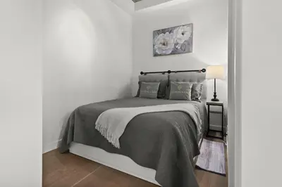 a bedroom with a bed in a white room at GlobalStay Modern Condos Downtown Calgary in Calgary