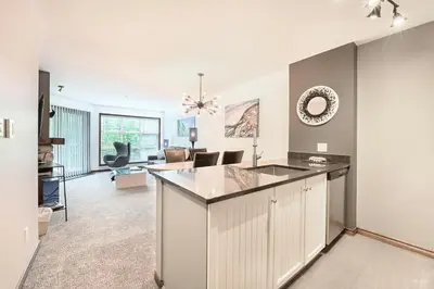 a kitchen and living room with a large island at The Best ski-in/ski-out at The Aspens in Whistler