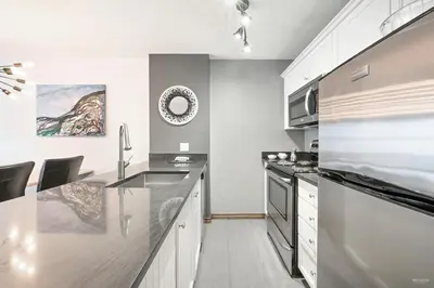 a kitchen with a sink and a counter top at The Best ski-in/ski-out at The Aspens in Whistler