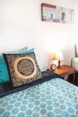 a bedroom with a bed with a pillow and a table at Willow Grove B&B Inn in Horsefly