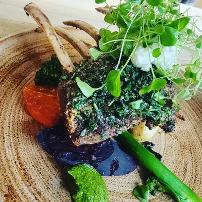 a plate of food with a piece of meat and vegetables at Storm Mountain Lodge & Cabins in Banff