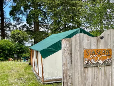 a wooden fence with a tent on top of it at So Damn Lucky Glamping in Ucluelet
