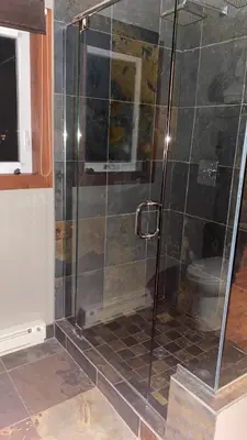 a shower with a glass door in a bathroom at Wesbert Winery & Guest Suites in Penticton
