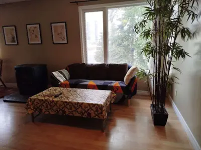 a living room with a couch and a coffee table at Jenny Guest House in Yellowknife
