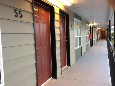 an empty hallway of a building with the and doors at Prince Motel in Prince George