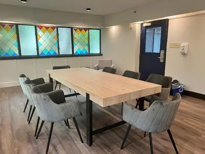 a conference room with a wooden table and chairs at HI Vancouver Downtown - Hostel in Vancouver