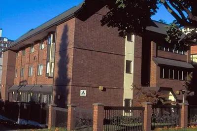 a brick building with a fence in front of it at HI Vancouver Downtown - Hostel in Vancouver