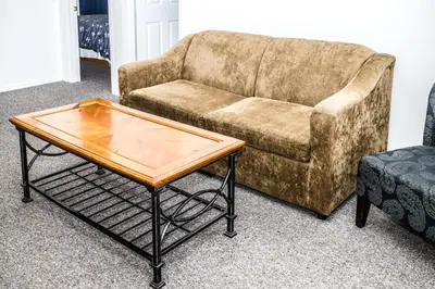 a living room with a couch and a coffee table at Crescent Motel in Radium Hot Springs