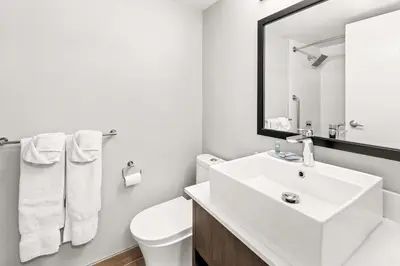 a white bathroom with a sink and a toilet at Best Western Cowichan Valley Inn in Duncan