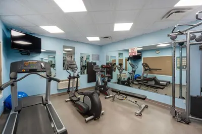 a gym with several treadmills and cardio machines at Best Western High Road Inn in Edson