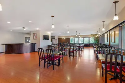 a dining room with tables and chairs and a bar at Best Western Northgate in Nanaimo