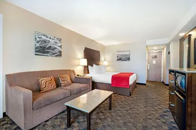 a hotel room with a bed and a couch at Best Western Northgate in Nanaimo