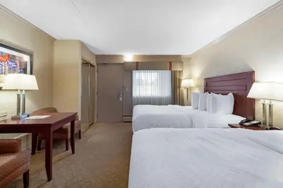 a hotel room with two beds and a desk at Best Western PLUS City Centre Inn in Edmonton