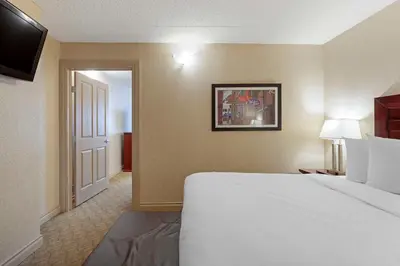 a hotel room with a bed and a door at Best Western PLUS City Centre Inn in Edmonton