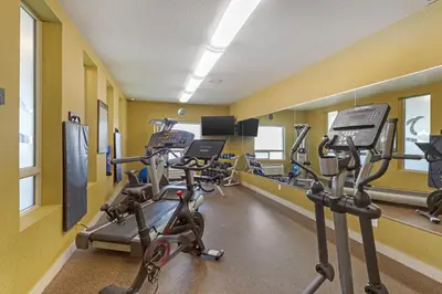 a gym with several treadmills and elliptical machines at Best Western Plus Sherwood Park in Sherwood Park