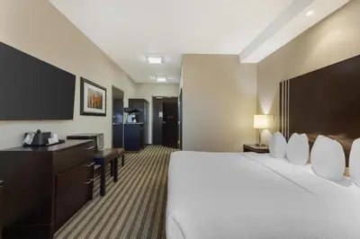 a hotel room with a large bed and a desk at Best Western Plus Sherwood Park in Sherwood Park