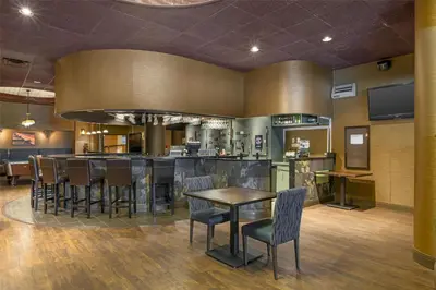 a bar in a restaurant with chairs and a table at Best Western Terrace Inn in Terrace