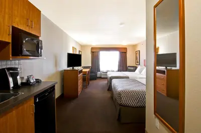 a hotel room with a bed and a living room at Canalta Provost in Provost