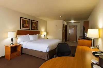 a hotel room with a bed and a desk at Canalta Provost in Provost