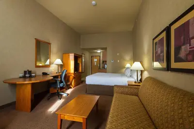 a hotel room with a bed and a desk at Canalta Provost in Provost