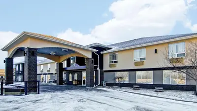 a large building with snow on the ground at Canalta Provost in Provost
