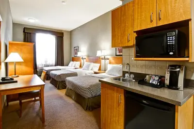 a hotel room with two beds and a living room at Canalta Provost in Provost