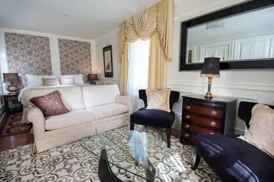 a living room with a couch and a bed at The Craigmyle Inn in Victoria