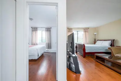 a room with two beds and a living room at Croft Inn Motel in Crofton