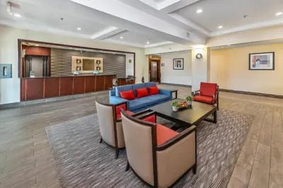 a living room with a couch and a table and chairs at Comfort Inn in Dawson Creek