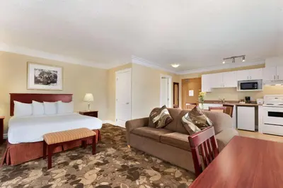 a hotel room with a bed and a couch at Nova Inn Yellowknife in Yellowknife