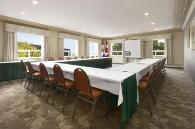 a large meeting room with a long table and chairs at Nova Inn Yellowknife in Yellowknife