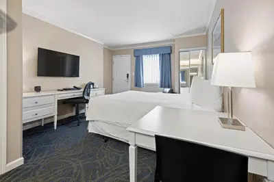 a hotel room with a bed and a desk at Glenwood Inn & Suites in Trail