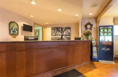 a waiting room with a large wooden bar at Grama's Inn in Prince George