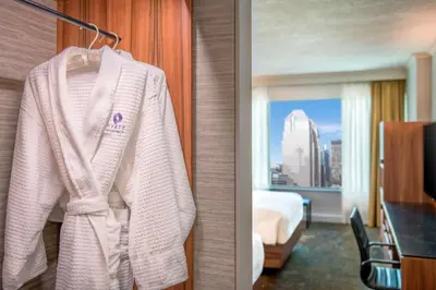 a white robe hanging in a hotel room at Hyatt Regency Calgary in Calgary