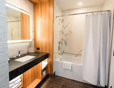 a bathroom with a sink and a tub and a shower at Hyatt Regency Calgary in Calgary