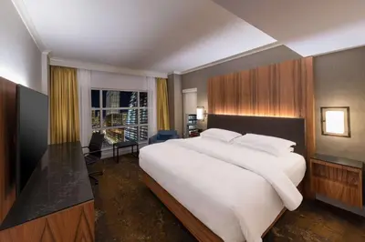 a bedroom with a large white bed and a window at Hyatt Regency Calgary in Calgary