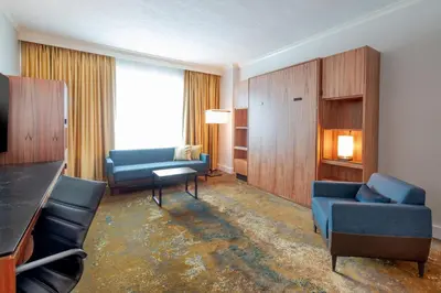 a living room with a blue couch and chairs at Hyatt Regency Calgary in Calgary