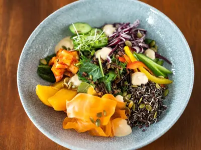 a blue bowl of food with vegetables in it at Hyatt Regency Calgary in Calgary