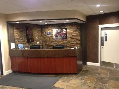 a lobby with a reception counter in a building at Days Inn by Wyndham Sylvan Lake in Sylvan Lake