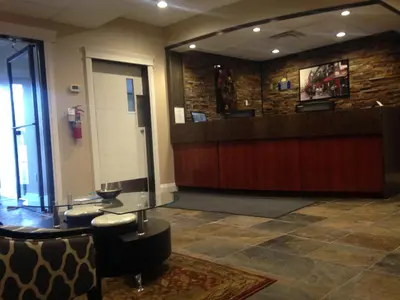 a lobby with a counter and a waiting area at Days Inn by Wyndham Sylvan Lake in Sylvan Lake