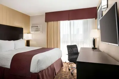 a hotel room with a bed and a desk at Days Inn by Wyndham Sylvan Lake in Sylvan Lake