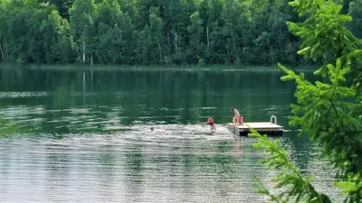 a couple of people in a dock in a lake at Jasper Way Inn Resort & Campground in Clearwater