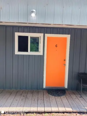 an orange door and a window on a building at Jasper Way Inn Resort & Campground in Clearwater