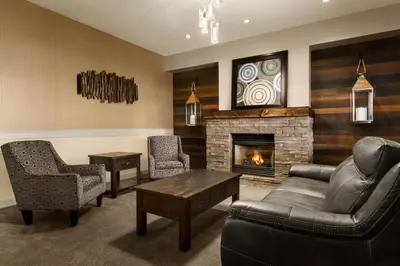 a living room with a couch and a fireplace at Days Inn & Suites by Wyndham Brooks in Brooks