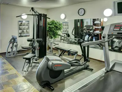 a gym with a treadmill and elliptical machines at Lakeview Inns & Suites - Slave Lake in Slave Lake