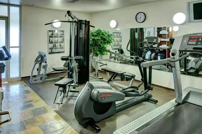 a gym with treadmills and machines in a room at Lakeview Inns & Suites - Slave Lake in Slave Lake