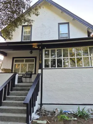 a house with a staircase leading to the front door at John's House in Vancouver West in Vancouver