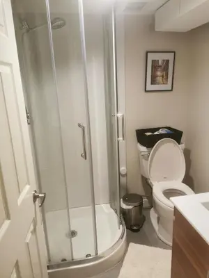 a bathroom with a shower and a toilet at John's House in Vancouver West in Vancouver