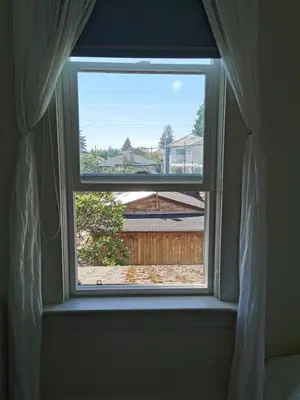 a window with a view of a train at John's House in Vancouver West in Vancouver