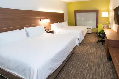 a hotel room with two beds and a flat screen tv at Holiday Inn Express & Suites - North Battleford by IHG in North Battleford